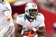 GLENDALE, AZ - SEPTEMBER 30: Quarterback Ryan Tannehill #17 of the Miami Dolphins hands off the football to running back Lamar Miller #26 during the NFL game against the Arizona Cardinals at the University of Phoenix Stadium on September 30, 2012 in Glendale, Arizona. The Carindals defeated the Dolphins 24-21 in overtime. (Photo by Christian Petersen/Getty Images)