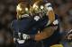 SOUTH BEND, IN - SEPTEMBER 22: Manti Te'o #5 of the Notre Dame Fighting Irish (R) gets a hug from Robby Roma #9 after an interception against the Michigan Wolverines at Notre Dame Stadium on September 22, 2012 in South Bend, Indiana. Notre Dame defeated Michigan 13-6. (Photo by Jonathan Daniel/Getty Images)