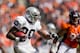 DENVER, CO - SEPTEMBER 30: Running back Darren McFadden #20 of the Oakland Raiders runs with the football as defensive tackle Derek Wolfe #95 of the Denver Broncos looks to make the tackle during the second quarter at Sports Authority Field Field at Mile High on September 30, 2012 in Denver, Colorado. (Photo by Justin Edmonds/Getty Images)