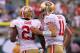 Sept 30, 2012; East Rutherford, NJ, USA; San Francisco 49ers quarterback Alex Smith (11) and running back Frank Gore (21) run off the field after Gore's touchdown during the second half at MetLife Stadium. The 49ers defeated the Jets 34-0. Mandatory Credit: Ed Mulholland-US PRESSWIRE