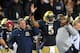 Oct. 6, 2012; Chicago, IL, USA; Notre Dame Fighting Irish quarterback Everett Golson (5) signals for a touchdown on a reviewed play as Head coach Brian Kelly watches from the sideline in the first quarter against the Miami Hurricanes at Soldier Field. Notre Dame won 41-3. Mandatory Credit: Matt Cashore-US PRESSWIRE