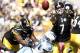 PITTSBURGH, PA - OCTOBER 09: Ben Roethlisberger #7 of the Pittsburgh Steelers throws a shovel pass while being tackled by Derrick Morgan #90 of the Tennessee Titans during the game on October 9, 2011 at Heinz Field in Pittsburgh, Pennsylvania. (Photo by Jared Wickerham/Getty Images)