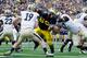 ANN ARBOR, MI - OCTOBER 29: Mike Martin #68 of the Michigan Wolverines gets around the block of Peters Drey #67 of the Purdue Boilermakers on his way to sacking Caleb TerBush #19 for a saftey at Michigan Stadium on October 29, 2011 in Ann Arbor, Michigan. (Photo by Gregory Shamus/Getty Images)
