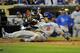 SAN DIEGO, CA - SEPTEMBER 25: Shane Victorino #8 of the Los Angeles Dodgers is tagged out at the plate by Yasmani Grandal #12 of the San Diego Padres as he tries to score during the second inning of a baseball game at Petco Park on September 25, 2012 in San Diego, California. (Photo by Denis Poroy/Getty Images)