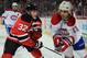 Scott Gomez of the Montreal Canadiens about to be checked by then-New Jersey Devil Matt Taormina.