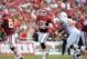 Oct 13, 2012; Dallas, TX, USA; Oklahoma Sooner quarterback Landry Jones (12) throws in the pocket against the Texas Longhorns during the red river rivalry at the Cotton Bowl. Mandatory Credit: Matthew Emmons-US PRESSWIRE