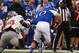 Oct 13, 2012; Lawrence, KS, USA; Kansas Jayhawks quarterback Dayne Crist (10) escapes the grasp of Oklahoma State Cowboys defensive tackle Calvin Barnett (99) in the first half at Memorial Stadium. Mandatory Credit: John Rieger-US PRESSWIRE