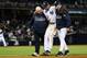 NEW YORK, NY - OCTOBER 13: Derek Jeter #2 of the New York Yankees is carried off of the field by trainer Steve Donohue (L) and manager Joe Girardi after Jeter injured his leg in the top of the 12th inning against the Detroit Tigers during Game One of the American League Championship Series at Yankee Stadium on October 13, 2012 in the Bronx borough of New York City, New York. (Photo by Al Bello/Getty Images)