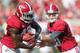 TUSCALOOSA, AL - SEPTEMBER 22: Quarterback AJ McCarron #10 of the Alabama Crimson Tide hands the ball off to running back Eddie Lacy #42 while playing against the Florida Atlantic Owls on September 22, 2012 at Bryant-Denny Stadium in Tuscaloosa, Alabama. Alabama defeated Florida Atlantic 40-7. (Photo by Michael Chang/Getty Images)