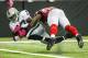 October 14, 2012; Atlanta, GA, USA; Oakland Raiders wide receiver Denarius Moore (17) dives for a touchdown past Atlanta Falcons middle linebacker Akeem Dent (52) in the first half at the Georgia Dome. Mandatory Credit: Daniel Shirey-US PRESSWIRE