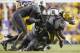 October 13, 2012; Baton Rouge, LA, USA; LSU Tigers running back Spencer Ware (11) is brought down by South Carolina Gamecocks defensive end Chaz Sutton (90) during the second half at Tiger Stadium. LSU won 23-21. Mandatory Credit: Crystal LoGiudice-US PRESSWIRE