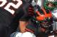 Nov 20, 2010; Princeton, NJ, USA; Princeton Tigers running back Brian Mills (20) is stopped for no gain by Dartmouth Big Green defensive end Buddy Benaderet (92) and defensive tackle Eddie Smith (99) with help from defensive back Mike Banaciski (45) and linebacker Luke Hussey (49). Dartmouth Big Green defeats Princeton Tigers 31-0. Mandatory Credit: Jim O'Connor-US PRESSWIRE