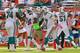 MIAMI GARDENS, FL - OCTOBER 14: Ryan Tannehill #17 and John Jerry #74 of the Miami Dolphins congratulates Marlon Moore #14 after a touchdown during a game against the St. Louis Rams at Sun Life Stadium on October 14, 2012 in Miami Gardens, Florida. (Photo by Mike Ehrmann/Getty Images)