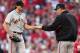 Giants manager Bruce Bochy (right) receives the ball from pitcher Barry Zito (left) as he leaves the game.