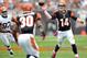 Oct 14, 2012; Cleveland, OH, USA; Cincinnati Bengals quarterback Andy Dalton (14) drops a pass off to running back Cedric Peerman (30) in the third quarter against the Cleveland Browns at Cleveland Browns Stadium. Mandatory Credit: David Richard-US PRESSWIRE