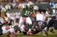 Oct 8, 2012; East Rutherford, NJ, USA; New York Jets quarterback Tim Tebow (15) carries the ball as Houston Texans players Danieal Manning (38), Earl Mitchell (92), Bradie James (53) and J. J. Watt (99) defend at MetLife Stadium. Mandatory Credit: Kirby Lee/Image of Sport-US PRESSWIRE