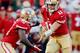 SAN FRANCISCO, CA - OCTOBER 18: Quarterback Alex Smith #11 hands off to running back Frank Gore #21 of the San Francisco 49ers against the Seattle Seahawks in the first quarter on October 18, 2012 at Candlestick Park in San Francisco, California. (Photo by Brian Bahr/Getty Images)