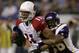 MINNEAPOLIS, MN - NOVEMBER 26: Larry Fitzgerald #11 of the Arizona Cardinals attempts to break free from Antoine Winfield #26 of the Minnesota Vikings at the Hubert H. Humprey Metrodome November 26, 2006 in Minneapolis, Minnesota. (Photo by Matthew Stockman/Getty Images)