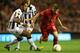 LIVERPOOL, ENGLAND - OCTOBER 04: Fabio Borini of Liverpool competes with Medhi Benatia of Udinese Calcio during the UEFA Europa League Group A match between Liverpool and Udinese at Anfield on October 4, 2012 in Liverpool, England. (Photo by Clive Brunskill/Getty Images)