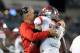 TAMPA, FL - SEPTEMBER 13: Head coach Kyle Flood of the Rutgers Scarlet Knights hugs defensive back Wayne Warren #27 after a fourth-quarter interception in the end zone against the South Florida Bulls at Raymond James Stadium September 13, 2012 in Tampa, Florida. Rutgers won 23-13. (Photo by Al Messerschmidt/Getty Images)