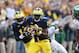 ANN ARBOR, MI - OCTOBER 20: Fitzgerald Toussaint #28 of the Michigan Wolverines runs for a first down as Isaigh Lewis #9 of the Michigan State Spartans attemps to make the stop during the game at Michigan Stadium on October 20, 2012 in Ann Arbor, Michigan. The Wolverines defeated the Spartans 12-10. (Photo by Leon Halip/Getty Images)