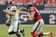 HOUSTON,TX - OCTOBER 21: Joe Flacco #5 of the Baltimore Ravens scrambles out of the pocket as he is pressured by Connor Barwin #98 of the Houston Texans at Reliant Stadium on October 21, 2012 in Houston, Texas. Houston won 43-13. (Photo by Bob Levey/Getty Images)