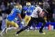 Dalton Hillard trying to make a tackle on an ASU receiver