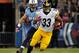NASHVILLE, TN - OCTOBER 11: Isaac Redman #33 of the Pittsburgh Steelers rushes past Colin McCarthy #52 of the Tennessee Titans at LP Field on October 11, 2012 in Nashville, Tennessee. (Photo by Frederick Breedon/Getty Images)