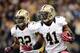 NEW ORLEANS, LA - OCTOBER 07: Roman Harper #41 of the New Orleans Saints returns an interception with the help of Johnny Patrick #32 during a 31-24 win over the San Diego Chargers at Mercedes-Benz Superdome on October 7, 2012 in New Orleans, Louisiana. (Photo by Harry How/Getty Images)