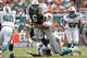 MIAMI GARDENS, FL - SEPTEMBER 23: Jared Odrick #98 of the Miami Dolphins hits Mark Sanchez #6 of the New York Jets as he gets the ball away on September 23, 2012 at Sun Life Stadium in Miami Gardens, Florida. (Photo by Joel Auerbach/Getty Images)