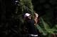 KUALA LUMPUR, MALAYSIA - OCTOBER 26: Tiger Woods of USA plays his 2nd shot on the 1st hole while police men looks on during Round One of the 2012 CIMB Classic at the Mines Resort and Golf Club on October 26, 2012 in Kuala Lumpur, Malaysia. (Photo by Stanley Chou/Getty Images)