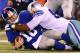 EAST RUTHERFORD, NJ - SEPTEMBER 05: Quarterback Eli Manning #10 of the New York Giants gets sacked by defensive end Jason Hatcher #97 of the Dallas Cowboys during the 2012 NFL season opener at MetLife Stadium on September 5, 2012 in East Rutherford, New Jersey. (Photo by Al Bello/Getty Images)