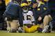 LINCOLN, NE - OCTOBER 27: Quarterback Denard Robinson #16 of the Michigan Wolverines is attended to by trainers after being injured during their game against the Nebraska Cornhuskers at Memorial Stadium on October 27, 2012 in Lincoln, Nebraska. (Photo by Eric Francis/Getty Images)