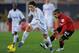 PALMA DE MALLORCA, SPAIN - JANUARY 14: Mesut Ozil (L) of Real Madrid gets past Damien Tissone of RCD Mallorca during the La Liga match between RCD Mallorca and Real Madrid at Iberostar Stadium on January 14, 2012 in Palma de Mallorca, Spain. (Photo by Denis Doyle/Getty Images)