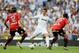MADRID, SPAIN - MAY 13: Cristiano Ronaldo (C) of Real Madrid CF is challenged by Chico Flores (L) and Cendros of RCD Mallorca during the La Liga match between Real Madrid CF and RCD Mallorca at Estadio Santiago Bernabeu on May 13, 2012 in Madrid, Spain. (Photo by Denis Doyle/Getty Images)