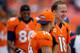 DENVER, CO - SEPTEMBER 30: Quarterback Peyton Manning #18 of the Denver Broncos smiles on the sideline while talking with wide receiver Brandon Stokley #14 during a game against the Oakland Raiders at Sports Authority Field Field at Mile High on September 30, 2012 in Denver, Colorado. The Broncos defeated the Raiders 37-6. (Photo by Justin Edmonds/Getty Images)