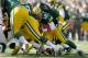 GREEN BAY, WI - OCTOBER 28: Aaron Rodgers #12 of the Green Bay Packers runs with the ball during the NFL game against the Jacksonville Jaguars at Lambeau Field on October 28, 2012 in Green Bay, Wisconsin. (Photo by Andy Lyons/Getty Images)