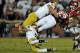 Oct. 27, 2012; Norman, OK, USA; Notre Dame Fighting Irish linebacker Manti Te'o (5) tackles Oklahoma Sooners running back Trey Millard (33) in the first quarter at Oklahoma Memorial Stadium. Mandatory Credit: Matt Cashore-US PRESSWIRE