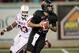 Sep 29, 2012; Jonesboro, AR, USA; Arkansas State Red Wolves quarterback Ryan Aplin (16) rushes as he is pressured by Western Kentucky Hilltoppers defensive lineman Quanterus Smith (93) at Liberty Bank Stadium. Western Kentucky defeated Arkansas State 26-13. Mandatory Credit: Nelson Chenault-US PRESSWIRE