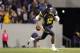 MORGANTOWN, WV - OCTOBER 20: Geno Smith #12 of the West Virginia Mountaineers is flushed out of the pocket against the Kansas State Wildcats during the game on October 20, 2012 at Mountaineer Field in Morgantown, West Virginia. The Wildcats defeated the Mountaineers 55-14. (Photo by Justin K. Aller/Getty Images)