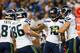 DETROIT, MI - OCTOBER 28: Sidney Rice #18 of the Seattle Seahawks celebrates a nine yard touchdown pass from Russell Wilson #3 and is congratulted by teammate Charly Martin #14 during the second quarter of the game at Ford Field on October 28, 2012 in Detroit, Michigan. (Photo by Leon Halip/Getty Images)