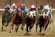 LOUISVILLE, KY - NOVEMBER 04: Jockey Corey Nakatani atop Thor's Echo (L), Cornelio Velasquez and Attila's Storm (C) and Patrick Valenzuela atop Bordonaro lead the pack around turn four in the TVG Breeders Cup Sprint race during the 2006 Breeders' Cup World Championships on November 4, 2006 at Churchill Downs in Louisville, Kentucky. Corey Nakatani and Thor's Echo won the race. (Photo by Matthew Stockman/Getty Images)