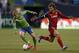 SEATTLE, WA - OCTOBER 17: Osvaldo Alonso #6 of the Seattle Sounders FC dribbles against Kyle Beckerman #5 of Real Salt Lake at CenturyLink Field on October 17, 2012 in Seattle, Washington. (Photo by Otto Greule Jr/Getty Images)