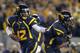 MORGANTOWN, WV - OCTOBER 20: Geno Smith #12 of the West Virginia Mountaineers hands the ball off against the Kansas State Wildcats during the game on October 20, 2012 at Mountaineer Field in Morgantown, West Virginia. (Photo by Justin K. Aller/Getty Images)