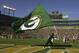 GREEN BAY, WI - OCTOBER 29: A cheedleader carries a Packer flag across the end zone after the Green Bay Packers scored a touchdown against the Arizona Cardinals on October 29, 2006 at Lambeau Field in Green Bay, Wisconsin. The Packers won 31-14. (Photo by Stephen Dunn/Getty Images)