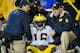 LINCOLN, NE - OCTOBER 27: Quarterback Denard Robinson #16 of the Michigan Wolverines is attended to by trainers after being injured during their game against the Nebraska Cornhuskers at Memorial Stadium on October 27, 2012 in Lincoln, Nebraska. (Photo by Eric Francis/Getty Images)