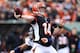 Under duress all day, Bengals quarterback Andy Dalton came close to matching Peyton Manning pass for pass.