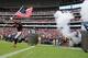 HOUSTON, TX- NOVEMBER 04: Houston Texans defensive end Antonio Smith #94 runs out holding the American Flag before playing against the Buffalo Bills on November 4, 2012 at Reliant Stadium in Houston, Texas. Texans won 21 to 9.(Photo by Thomas B. Shea/Getty Images)