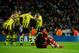 MADRID, SPAIN - NOVEMBER 06: Goalkeeper Iker Casillas (R) of Real Madrid sits defeated on the pitch while Mario Gotze of Borussia Dortmund celebrates with his teammates in the background after scoring his sides second goal during the UEFA Champions League group D match between Real Madrid and Borussia Dortmund at Estadio Santiago Bernabeu on November 6, 2012 in Madrid, Spain. (Photo by Jasper Juinen/Getty Images)