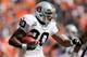 DENVER, CO - SEPTEMBER 30: Running back Darren McFadden #20 of the Oakland Raiders runs with the football as defensive tackle Derek Wolfe #95 of the Denver Broncos looks to make the tackle during the second quarter at Sports Authority Field Field at Mile High on September 30, 2012 in Denver, Colorado. (Photo by Justin Edmonds/Getty Images)